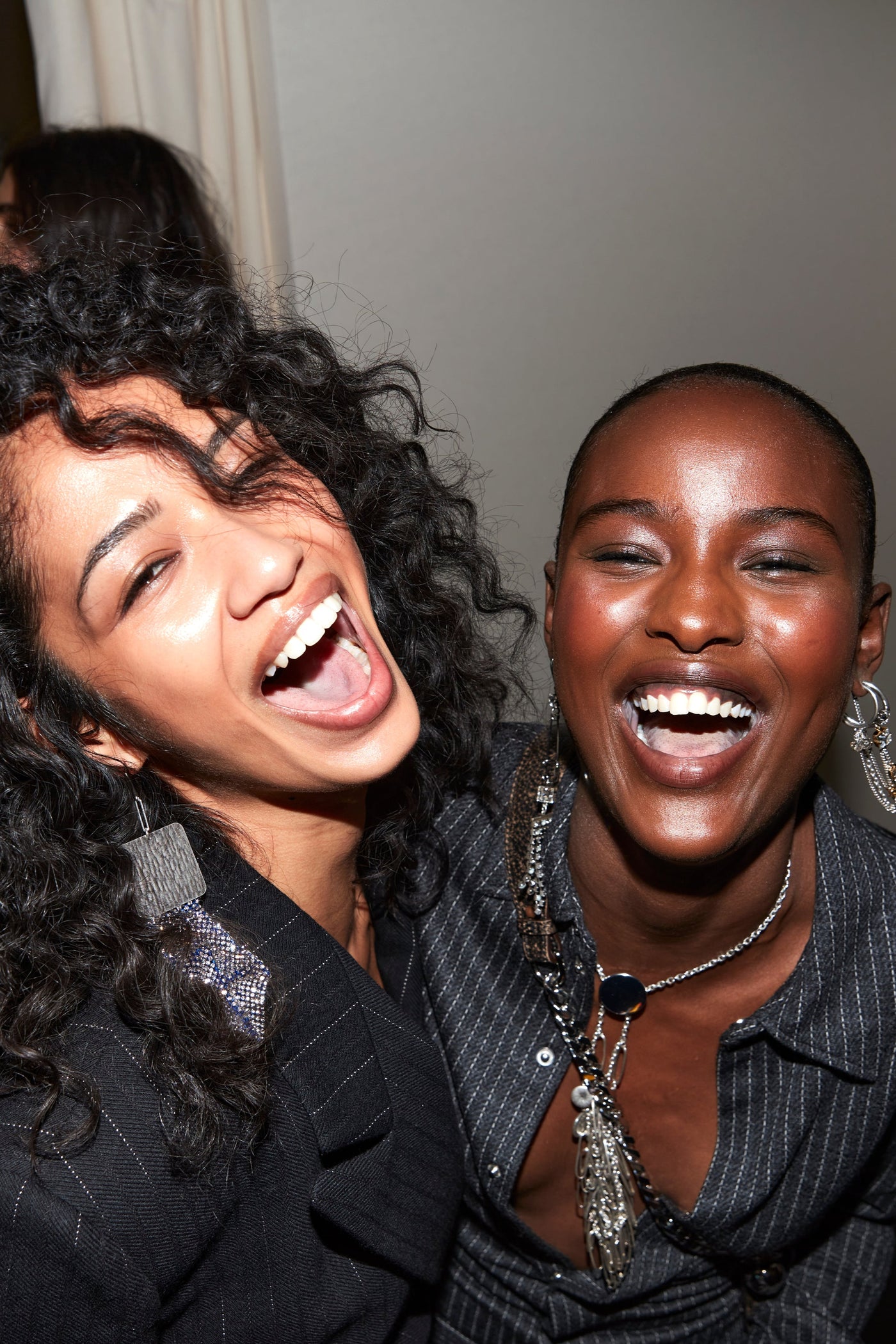 Laughing models are wearing the Maia jacket and Romea anthracite striped shirt both styled with silver jewels